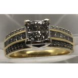An 18ct gold ring set with princess cut diamonds in square design.Approx size