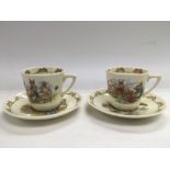 A pair of Royal Doulton Bunnykins cups and saucers.