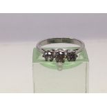 A white gold ring set with three diamonds, approx 1/2ct, approx 2.8g.