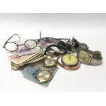 A box containing used and circulated world bank notes and coins, watches and other oddments.