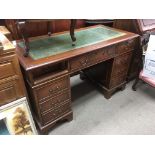 A reproduction mahogany desk with inset leather to