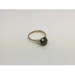 A gold and black diamond solitaire ring, approx 1.62g and approx size H-I. Please note gold mark