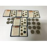 A collection of various commemorative coins including decimal coin presentation packs.