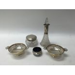 A small group of silver items to include a perfume bottle, tidy jar, two bowls and a smaller bowl.