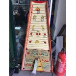 A shoot-a-penny table top game, with some old pennies.