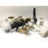 A collection of ceramic and porcelain ornaments including a Lladro dog Russian magpie an unusual