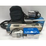 A boxed Minolta camera, Panasonic NVDS 60B digital video camera and a boxed tripod plus carry
