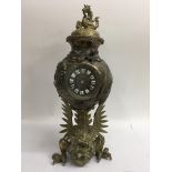 An interesting brass cased French clock with Japanese styling. Small crack to front glass. Height