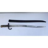 A French bayonet, possibly 19th Century with engraved blade spine. Scabbard included. Blade length