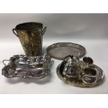 A box of various silver plated items including cutlery, trays and a tea service.