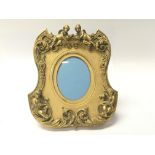 A Quality French Early 20th Century gilt metal picture frame with raised putti and scrolls height