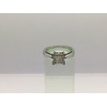 An 18ct white gold ring set with sixteen small princess cut diamonds, approx 4g and approx size M.