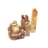 Three carved hardstone seals, a carved Buddha and another carved figure.