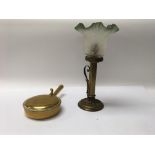 A Victorian brass column candle lamp with a green glass shade accompanied by a small brass lidded