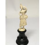 A carved late 19th Century Continental figure of a dancing lady on a turned wood pedestal total