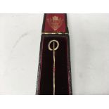 A gold tie pin in the form of a horse shoe fitted in original box - NO RESERVE