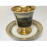 A Meissen Porcelain cabinet cup and saucer hand painted with a landscape view with applied gilt no