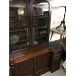 A Victorian mahogany bookcase the pair of glazed doors above a single drawer with cupboard doors