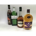 Four bottles of alcohol comprising Gordon's gin, Bacardi rum, Three Barrels brandy and Courvoisier