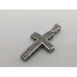 A white gold crucifix marked 10k and set with pave diamonds , approx 0.75ct and approx 7.45g.