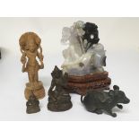 A carved coloured jade type stone and Indian bronzes and a carved wood figures.