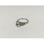 An 18ct marked white gold ring set with a white stone. Damaged band. Weight approx 2.9g.