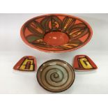 Four Poole pottery items.