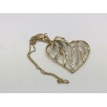 A 9ct gold heart shaped pendant set with small diamonds, approx 4.45g.