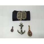 A group of brooches to include one in the shape of an anchor with black panels of sailor interest