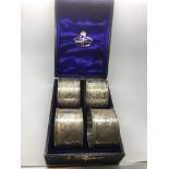 A quantity set of four engraved silver napkin rings in fitted box.Sheffield hallmarks for Martin