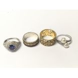 Four rings inset with coloured stones one marked silver (4)