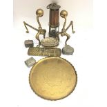 A collection of brass oddments to include a lamp, fire dogs and a crib board.