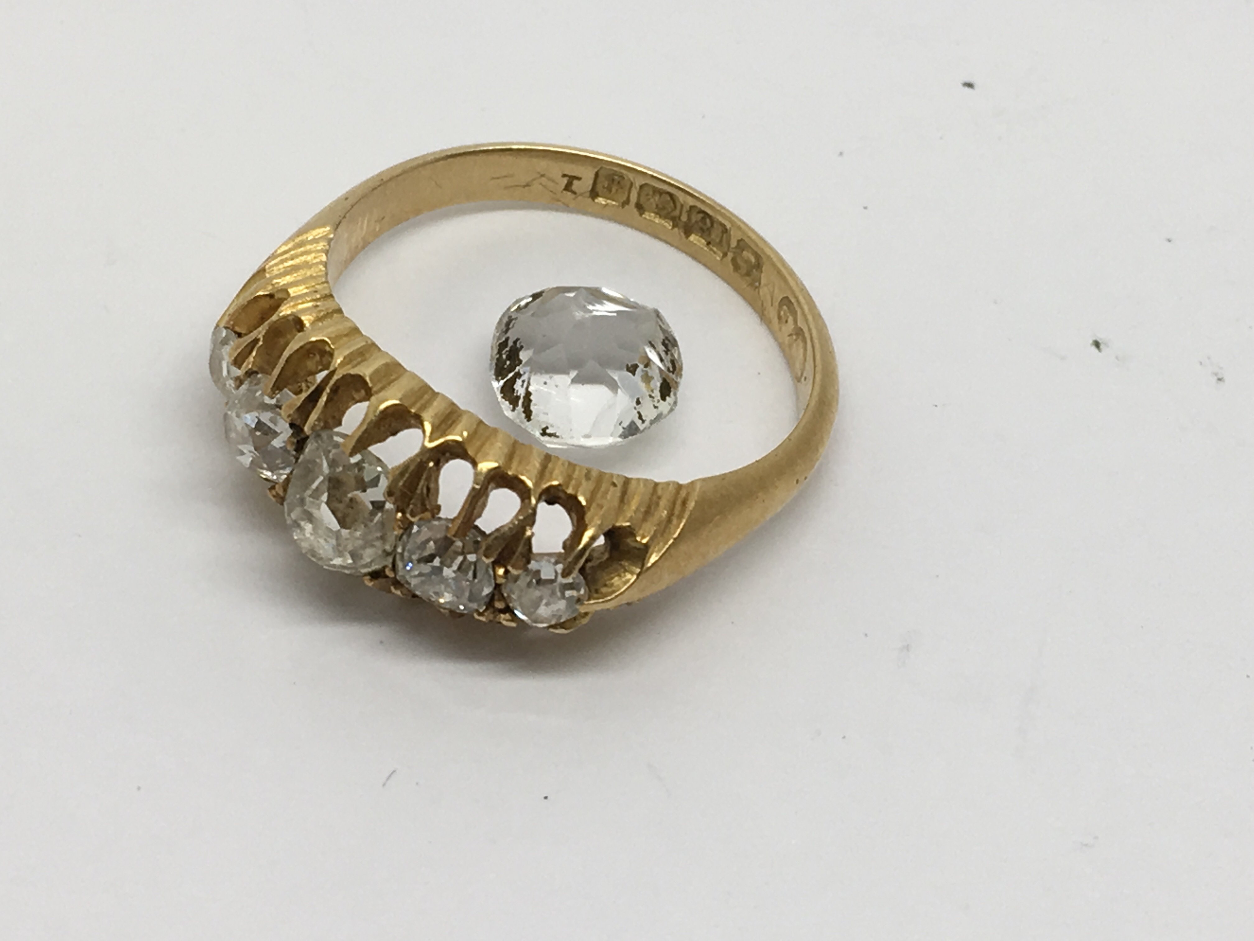 An 18ct gold ring set with a band of diamonds.Approx L, 3.86g.Sold with single glass stone - Image 2 of 2