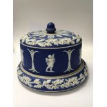 A Wedgwood Jasper ware cheese dish and cover of circular shape and of Neo-Classical design.