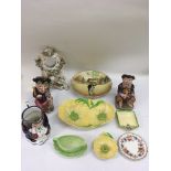 A Victorian porcelain clock face, Toby jugs and Carltonware ceramics