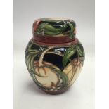 A Moorcroft ginger jar decorated with fruit and flowers, approx 11cm.
