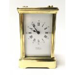 A working brass carriage clock made by Trimnell of Canterbury. The white dial presenting both