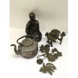A bronzed Buddha type figure, a brass Fu dog, a co