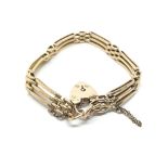 A 9ct gold gate bracelet with a heart shaped padlock clasp. Total weight approx 10.8 grams.