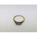 A 18 ct gold ring inset with three diamonds size J
