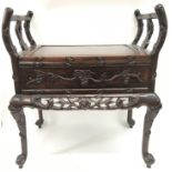 A carved Chinese hardwood seat with hinged top. Measures approx 63cm wide x 39cm deep x 70cm tall.