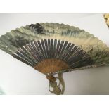 An oriental hand painted fan with applied mother of pearl.