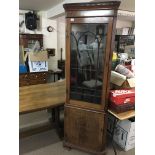 A George III Mahogany corner display cabinet with a dentil moulded cornice. Glazed door and