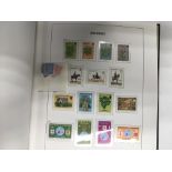 A Stanley Gibbons album of stamps including unused Queen Elizabeth II decimal stamps.