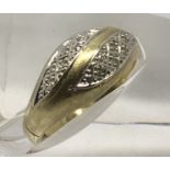 An 18ct gold ring set with small diamonds, 0.0.9.Approx O