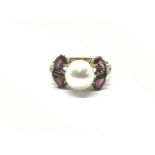 A ladies 9ct gold ring set with a central pearl fl