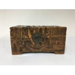 A carved oriental box with sailing design.