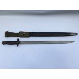 A British 1907 pattern bayonet with scabbard. Blade length approx 43cm, total 56cm.