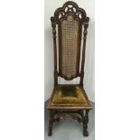 A late 17th century, cane highback chair with carved wood frame and later alterations.Approx 137cm