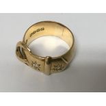 A 18 ct gold buckle ring inset with two diamonds 12 grams